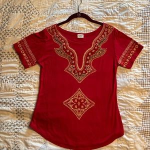 Red shirt with printed design and beadwork on the front
